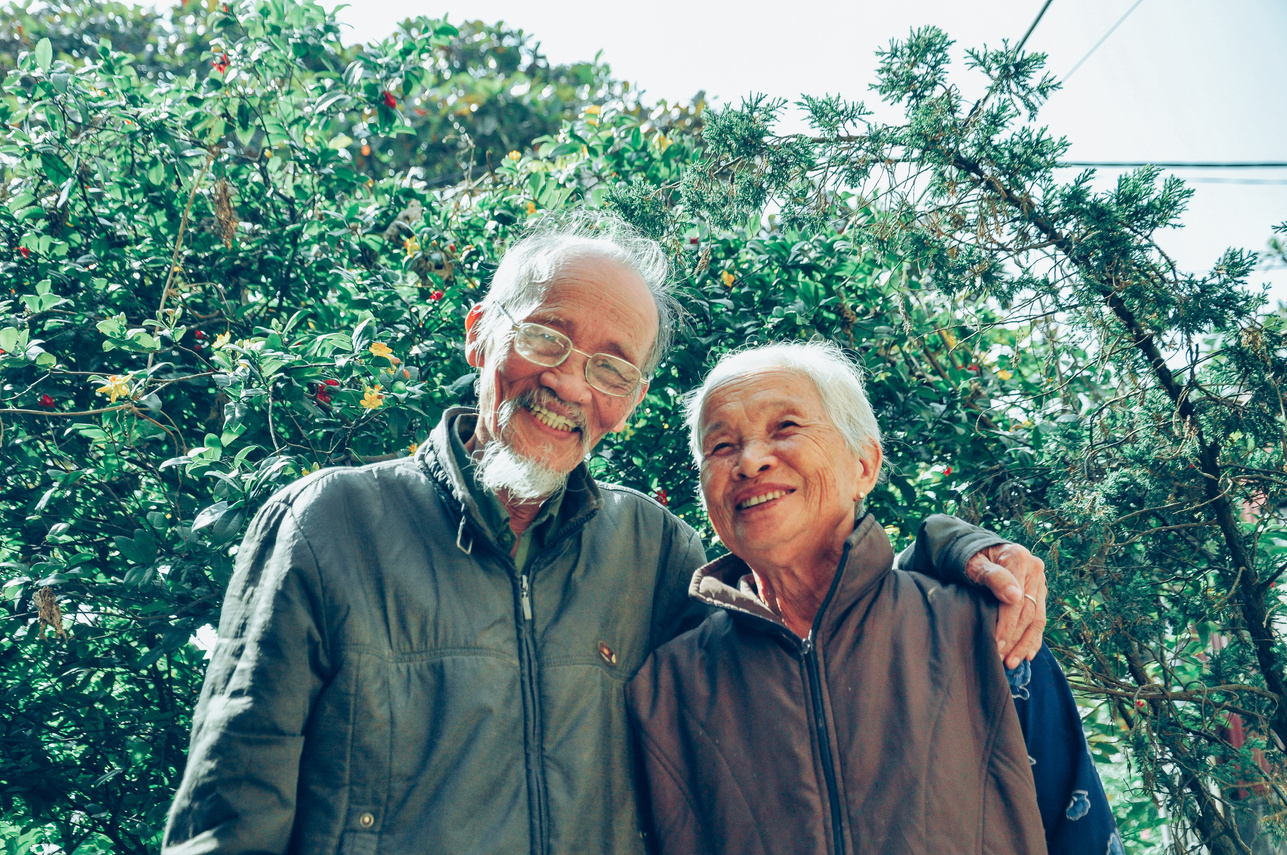 Smiling Man and Woman Wearing Jackets